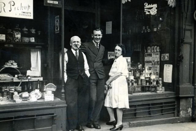 Albert Pickup, who went on to become Burnley's first Mormon mayor,  with his parents outside his mother's shop on Westgate, Burnley. She traded as Rose Pickup family grocer. The image was taken by Albert's girlfriend.