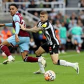 NEWCASTLE UPON TYNE, ENGLAND - SEPTEMBER 30: Kieran Trippier of Newcastle United challenges Aaron Ramsey of Burnley during the Premier League match between Newcastle United and Burnley FC at St. James Park on September 30, 2023 in Newcastle upon Tyne, England. (Photo by Nigel Roddis/Getty Images)