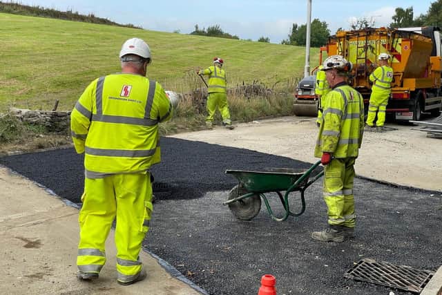 Cliviger resident Graham Knott today caught this image of workmen putting the final layer of tarmac on the stretch of Burnley Road that has been closed for a month for repair works after a sink hole appeared