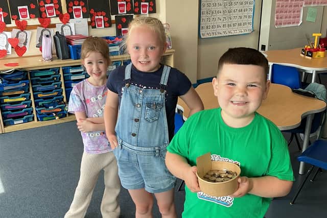 Reggie Alpaslan with two classmates at the Rare Disease Day at his school, Wheatley Lane Primary in Fence. Reggie has a condition known as Albright's hereditary osteotrophy