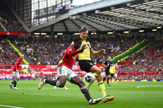 MANCHESTER, ENGLAND - APRIL 27: Kobbie Mainoo of Manchester United is challenged by Sander Berge of Burnley during the Premier League match between Manchester United and Burnley FC at Old Trafford on April 27, 2024 in Manchester, England. (Photo by Michael Regan/Getty Images)