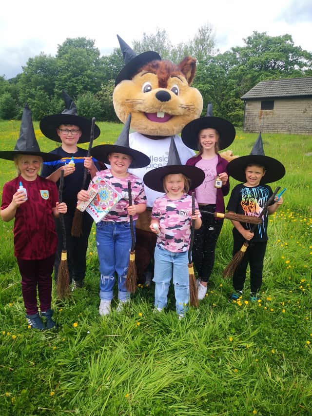 Paints at the ready – children and Penny, the hospice mascot, prepare for the Pendleside Witchfest art competition