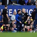 LIVERPOOL, ENGLAND - APRIL 21: Rui Pedro Silva, Assistant Manager of Nottingham Forest, speaks with Referee Anthony Taylor after being shown a yellow card during the Premier League match between Everton FC and Nottingham Forest at Goodison Park on April 21, 2024 in Liverpool, England. (Photo by Gareth Copley/Getty Images)