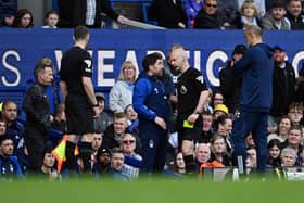 LIVERPOOL, ENGLAND - APRIL 21: Rui Pedro Silva, Assistant Manager of Nottingham Forest, speaks with Referee Anthony Taylor after being shown a yellow card during the Premier League match between Everton FC and Nottingham Forest at Goodison Park on April 21, 2024 in Liverpool, England. (Photo by Gareth Copley/Getty Images)