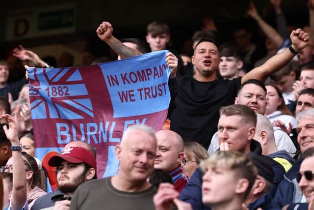 Burnley fans celebrate at the end of the English Premier League football match between Sheffield United and Burnley at Bramall Lane in Sheffield, northern England, on April 20, 2024. (Photo by Darren Staples / AFP) /