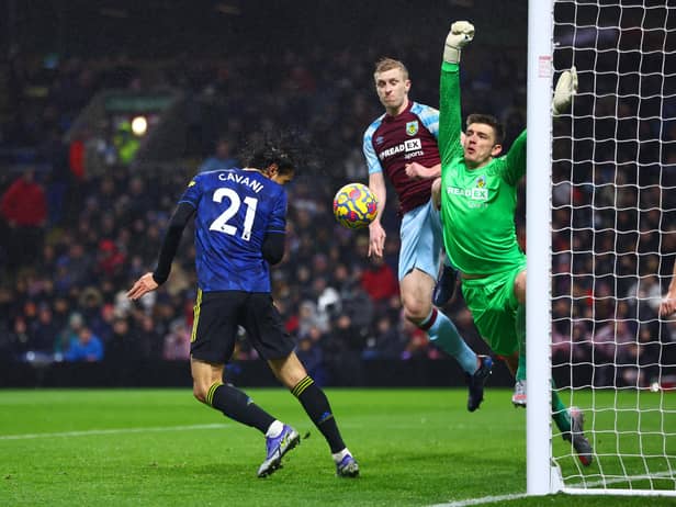 BURNLEY, ENGLAND - FEBRUARY 08: Edinson Cavani of Manchester United attempts a header which was saved by Nick Pope of Burnley during the Premier League match between Burnley and Manchester United at Turf Moor on February 08, 2022 in Burnley, England. (Photo by Clive Brunskill/Getty Images)