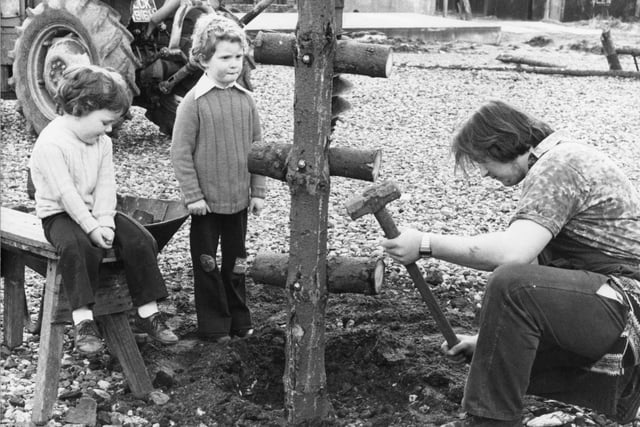 We're in the 1970s now, and Paul, three, and Ian Yates, six, watch David Hehir, 19, build a log ladder at a "peppercorn play-area" at Oxford Street in Preston's Avenham district