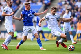 LEICESTER, ENGLAND - SEPTEMBER 25: James Tarkowski of Burnley battles for possession with Harvey Barnes of Leicester City    during the Premier League match between Leicester City and Burnley at The King Power Stadium on September 25, 2021 in Leicester, England. (Photo by Clive Mason/Getty Images)