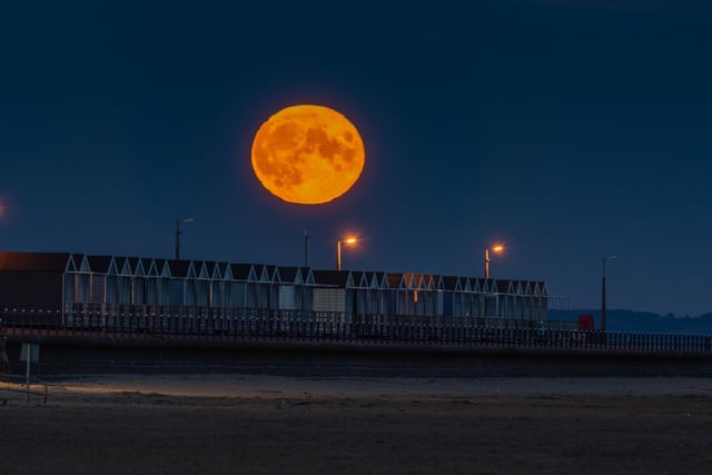The moon rises over St Annes beach