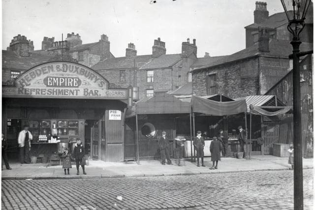 Around the Market there were numerous businesses that depended on it. One was Hebden and Duxbury’s Empire Refreshment Bar, noted for its pie and peas. The premises were on Market Street opposite the Corporation Arms. The street behind is Standish Street which, at one time, was home to the Butcher’s Arms, an Old Brewery pub, which can be seen to the right.
