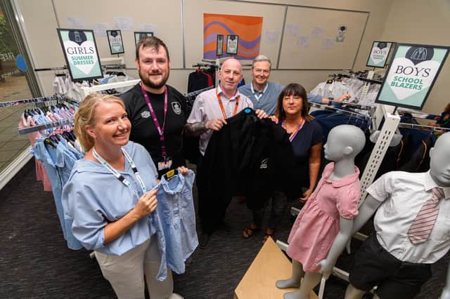 Volunteers (left to right) Cathryn Swift, Nathan Norris, Mark Hull, Dominic Cooper and Maria Bolton inside the free school uniform shop that opened in Burnley yesterday.