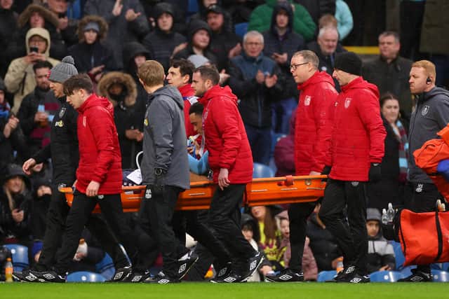 BURNLEY, ENGLAND - FEBRUARY 17: Aaron Ramsey of Burnley receives medical treatment and is stretchered off during the Premier League match between Burnley FC and Arsenal FC at Turf Moor on February 17, 2024 in Burnley, England. (Photo by Marc Atkins/Getty Images)