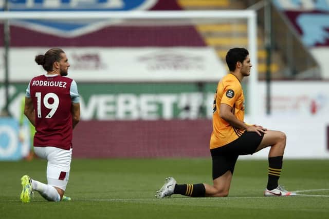 Burnley's English striker Jay Rodriguez (L) and Wolverhampton Wanderers' Mexican striker Raul Jimenez kneel ahead of the English Premier League football match between Burnley and Wolverhampton Wanderers at Turf Moor in Burnley, north-west England on July 15, 2020. (Photo by Clive Brunskill / POOL / AFP) / RESTRICTED TO EDITORIAL USE. No use with unauthorized audio, video, data, fixture lists, club/league logos or 'live' services. Online in-match use limited to 120 images. An additional 40 images may be used in extra time. No video emulation. Social media in-match use limited to 120 images. An additional 40 images may be used in extra time. No use in betting publications, games or single club/league/player publications. /  (Photo by CLIVE BRUNSKILL/POOL/AFP via Getty Images)