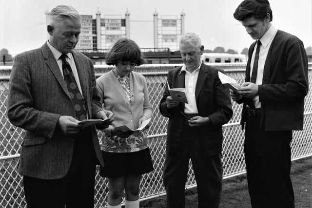 Taking a day off from the Dragoon Hotel in Hebrew Road, landlord George Kirker studies the race card in search of another winner. With him are his daughter, Barbara, aged 11, his son Royden and Mr Jim Lord.