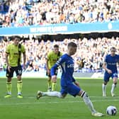 Chelsea's English midfielder #20 Cole Palmer (C) scores the opening goal from the penalty spot during the English Premier League football match between Chelsea and Burnley at Stamford Bridge in London on March 30, 2024. (Photo by Glyn KIRK / AFP)