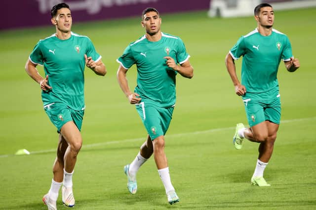 Morocco's defender Achraf Hakimi (C) jogs with Morocco's defender Naif Aguerd (L) and Morocco's midfielder Anass Zaroury at Al Duhail SC in Doha on November 19, 2022, ahead of the Qatar 2022 World Cup football tournament. (Photo by FADEL SENNA / AFP) (Photo by FADEL SENNA/AFP via Getty Images)