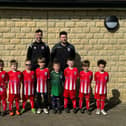 Lewis Tillotson and Nik Hothersall with one of Colne FC Juniors' under six teams.