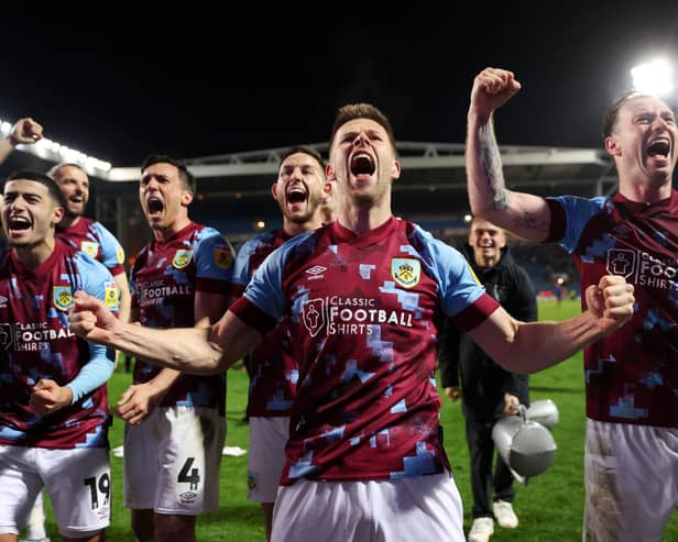 BLACKBURN, ENGLAND - APRIL 25: Johann Gudmundsson of Burnley celebrates alongside teammates towards the fans after winning the Sky Bet Championship following victory against the Blackburn Rovers and Burnley at Ewood Park on April 25, 2023 in Blackburn, England. (Photo by Matt McNulty/Getty Images)