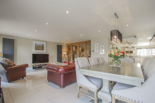 Through the kitchen and reception room you can access an extended family room