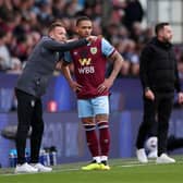 BURNLEY, ENGLAND - APRIL 13: Craig Bellamy, Assistant Manager of Burnley, speaks to Vitinho of Burnley during the Premier League match between Burnley FC and Brighton & Hove Albion at Turf Moor on April 13, 2024 in Burnley, England. (Photo by Lewis Storey/Getty Images)