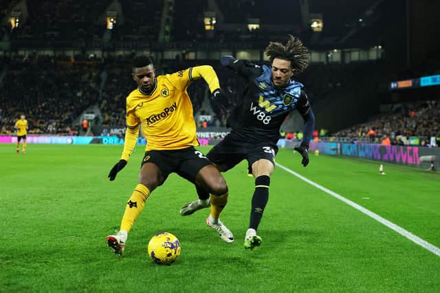 WOLVERHAMPTON, ENGLAND - DECEMBER 05: Nelson Semedo of Wolverhampton Wanderers is challenged by Luca Koleosho of Burnley during the Premier League match between Wolverhampton Wanderers and Burnley FC at Molineux on December 05, 2023 in Wolverhampton, England. (Photo by David Rogers/Getty Images)