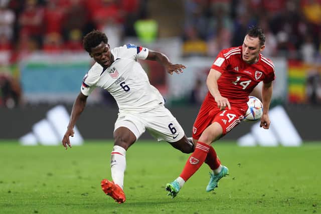 DOHA, QATAR - NOVEMBER 21: Connor Roberts of Wales battles for possession with Yunus Musah of United States during the FIFA World Cup Qatar 2022 Group B match between USA and Wales at Ahmad Bin Ali Stadium on November 21, 2022 in Doha, Qatar. (Photo by Buda Mendes/Getty Images)