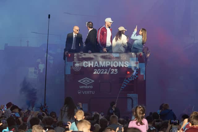 Burnley fans surround the buses carrying Burnley players on their victory parade around Burnley following promotion to the Premier League. Photo: Kelvin Stuttard