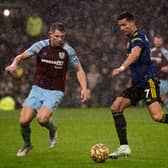 BURNLEY, ENGLAND - FEBRUARY 08: Cristiano Ronaldo of Manchester United in action with James Tarkowski of Burnley during the Premier League match between Burnley and Manchester United at Turf Moor on February 08, 2022 in Burnley, England. (Photo by Ash Donelon/Manchester United via Getty Images)