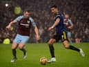 BURNLEY, ENGLAND - FEBRUARY 08: Cristiano Ronaldo of Manchester United in action with James Tarkowski of Burnley during the Premier League match between Burnley and Manchester United at Turf Moor on February 08, 2022 in Burnley, England. (Photo by Ash Donelon/Manchester United via Getty Images)