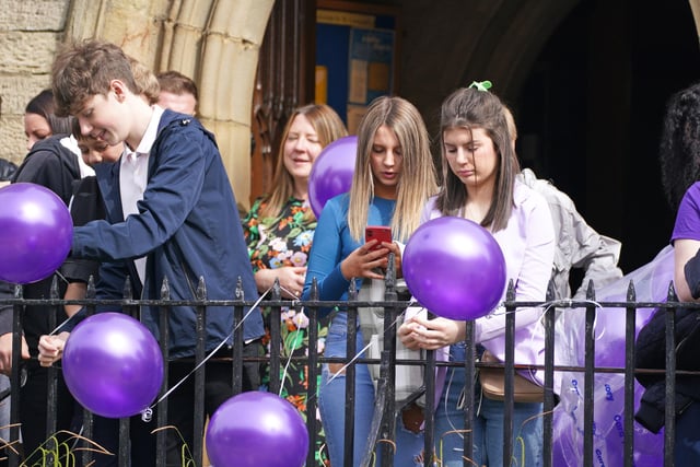 Mourners carrying purple balloons – Katie’s favourite colour – gathered outside St Leonard’s Church to prepare for the funeral. (Credit: PA/ Peter Byrne)