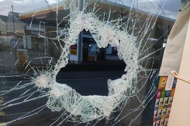 The smashed glass at Berry Lane Newsagents