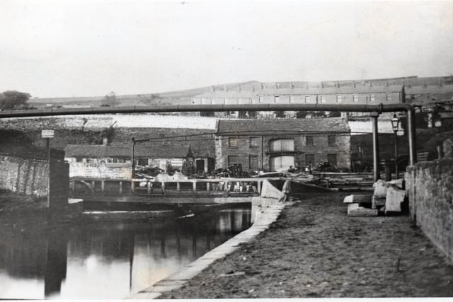 The old canal warehouse at Finsley Gate showing other buildings connected with the work of the Canal Company. In the foreground, left, is the original swing bridge which, until 1885, gave this part of Burnley its name.