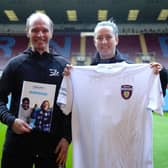 Mark Bennett, BLC health activator, and Lora Speak, BFCitC health and wellbeing officer, with the Fit Fans workbook and t-shirt