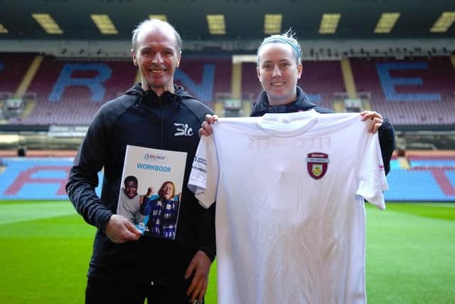Mark Bennett, BLC health activator, and Lora Speak, BFCitC health and wellbeing officer, with the Fit Fans workbook and t-shirt