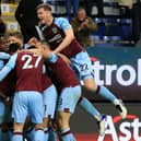 Burnley's Ivorian defender Maxwel Cornet (centre left) celebrates with teammates after scoring there third goal during the English Premier League football match between Burnley and Everton at Turf Moor in Burnley, north west England on April 6, 2022.