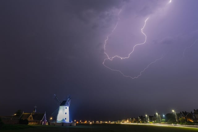 Lytham Windmill is lit up by a flash of lightning