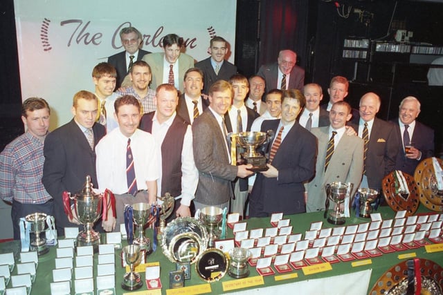 General circulation and marketing manager of the Lancashire Evening Post. Neil Mavers (centre right) presents the Division One championship trophy to Springfields FC captain Eddie Crawley and his team mates at the West Lancashire Football League annual presentation at Morecambe's Carleton Inn. Springfields took the title for the first time in 18 years, winning by one point from Fulwood Amateurs