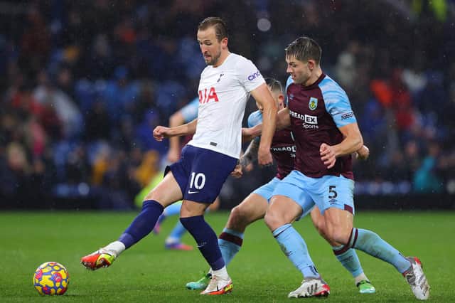 BURNLEY, ENGLAND - FEBRUARY 23: Harry Kane of Tottenham Hotspur is challenged by James Tarkowski of Burnley during the Premier League match between Burnley and Tottenham Hotspur at Turf Moor on February 23, 2022 in Burnley, England. (Photo by Alex Livesey/Getty Images)