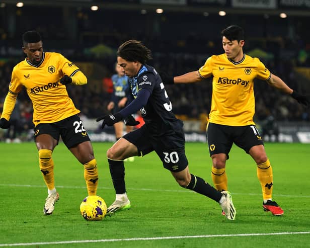 WOLVERHAMPTON, ENGLAND - DECEMBER 05: Luca Koleosho of Burnley controls the ball whilst under pressure from Nelson Semedo and Hwang Hee-Chan of Wolverhampton Wanderers during the Premier League match between Wolverhampton Wanderers and Burnley FC at Molineux on December 05, 2023 in Wolverhampton, England. (Photo by David Rogers/Getty Images)