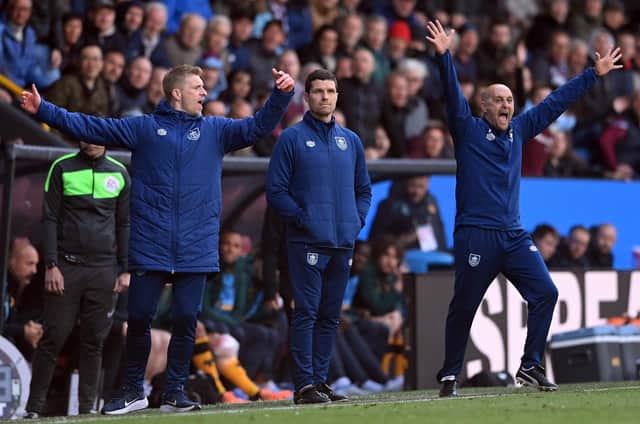 BURNLEY, ENGLAND - APRIL 24: Burnley interim coach Mike Jackson (c) Ben Mee (l) react on the touchline during the Premier League match between Burnley and Wolverhampton Wanderers at Turf Moor on April 24, 2022 in Burnley, England. (Photo by Stu Forster/Getty Images)