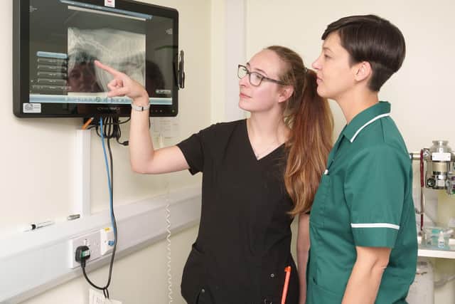 Vet Lauren Jolley and nurse Chanel Riley examining the X-ray at Stanely House