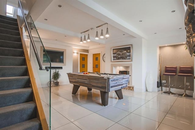 Spacious games room and stairs with glass balustrade