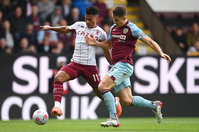 BURNLEY, ENGLAND - MAY 07: Ollie Watkins of Aston Villa battles for possession with James Tarkowski of Burnley during the Premier League match between Burnley and Aston Villa at Turf Moor on May 07, 2022 in Burnley, England. (Photo by Gareth Copley/Getty Images)