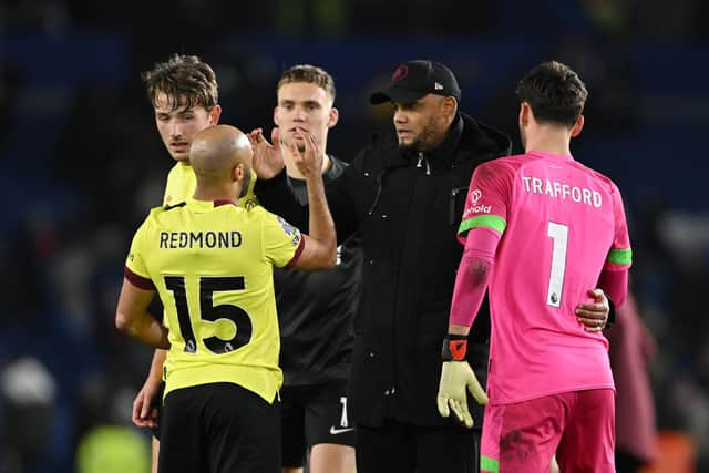 BRIGHTON, ENGLAND - DECEMBER 09: Vincent Kompany, Manager of Burnley, embraces his players Nathan Redmond (L) and James Trafford following the Premier League match between Brighton & Hove Albion and Burnley FC at American Express Community Stadium on December 09, 2023 in Brighton, England. (Photo by Mike Hewitt/Getty Images)