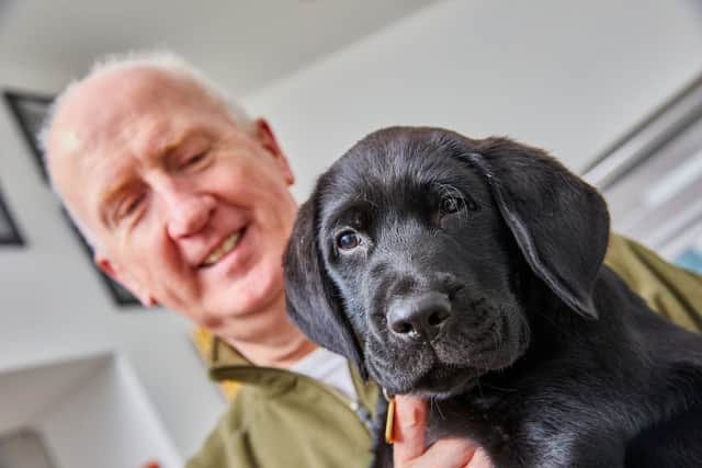 Puppy raiser Terry Finn, who trains and cares for puppies for the Guide Dogs charity, with his third pup Aero