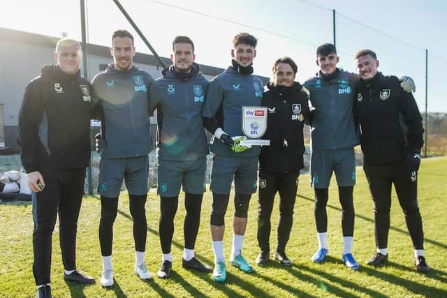 Trafford receives his award alongside head coach Scott Parker and the goalkeeping department.