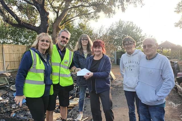 Members of Building a Better Brierfield (left), which donated £225 worth of B&Q vouchers to Brierfield Children's Community Allotment, with some of the latter's volunteers.