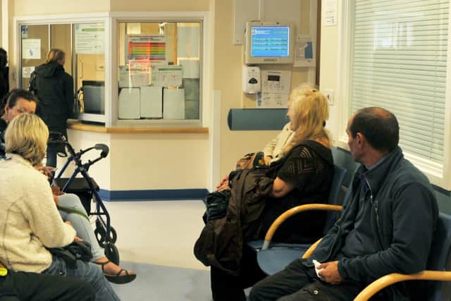 Patients in a GP waiting room.