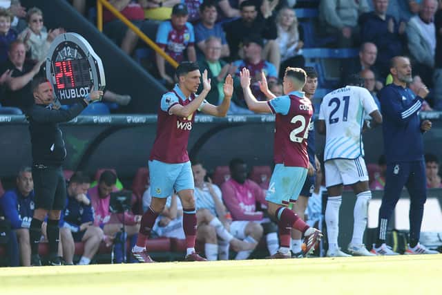 BURNLEY, ENGLAND - MAY 19: Jack Cork of Burnley embraces teammate Josh Cullen as he is substituted on during the Premier League match between Burnley FC and Nottingham Forest at Turf Moor on May 19, 2024 in Burnley, England. (Photo by Nathan Stirk/Getty Images)