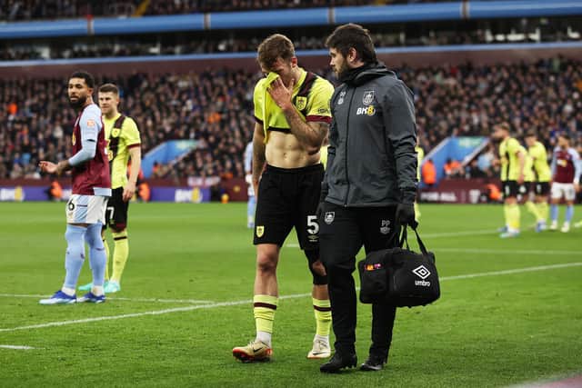 BIRMINGHAM, ENGLAND - DECEMBER 30: Jordan Beyer of Burnley leaves the field dejected after suffering an injury during the Premier League match between Aston Villa and Burnley FC at Villa Park on December 30, 2023 in Birmingham, England. (Photo by Ryan Pierse/Getty Images)